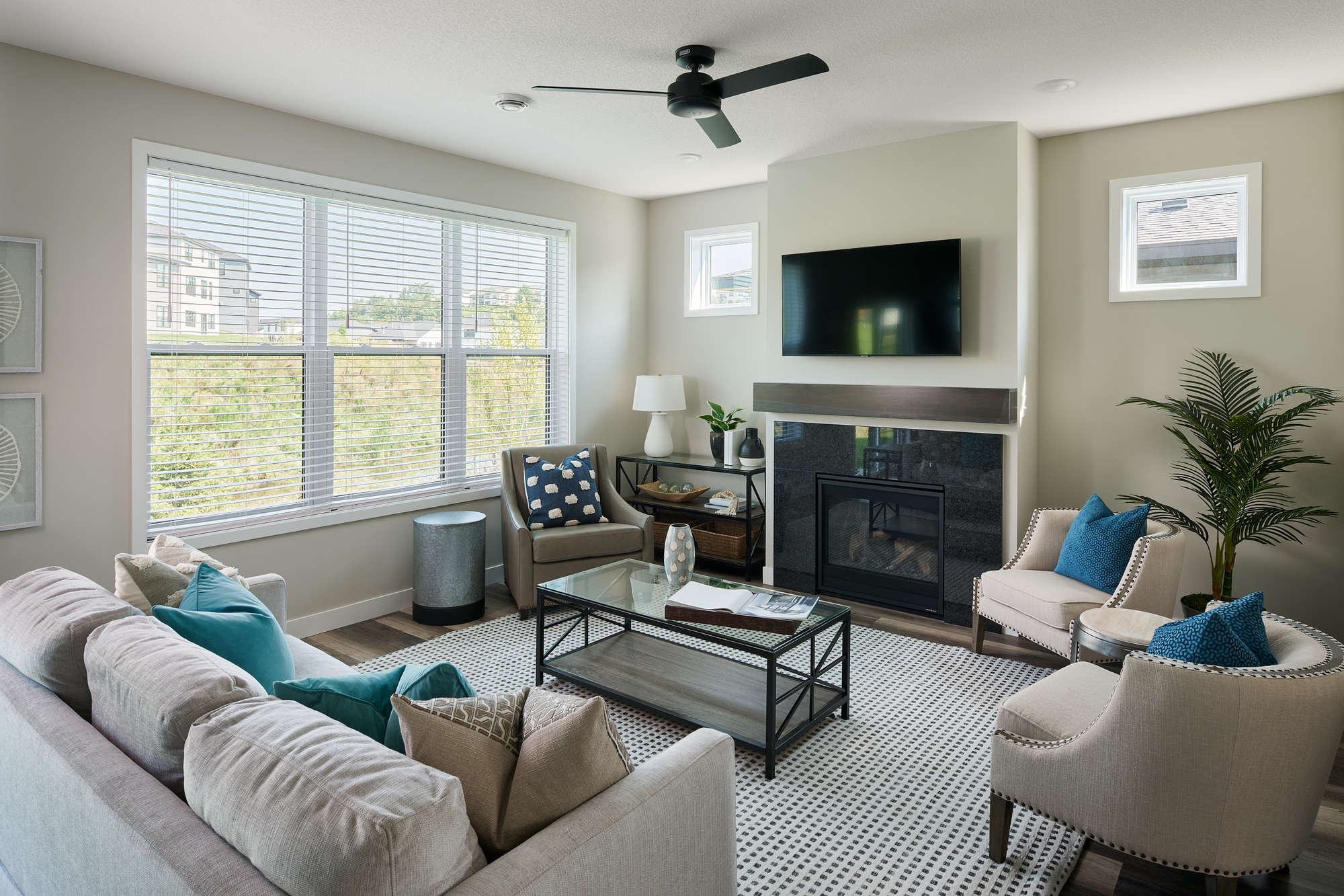 Modern living room with beige and blue accents.