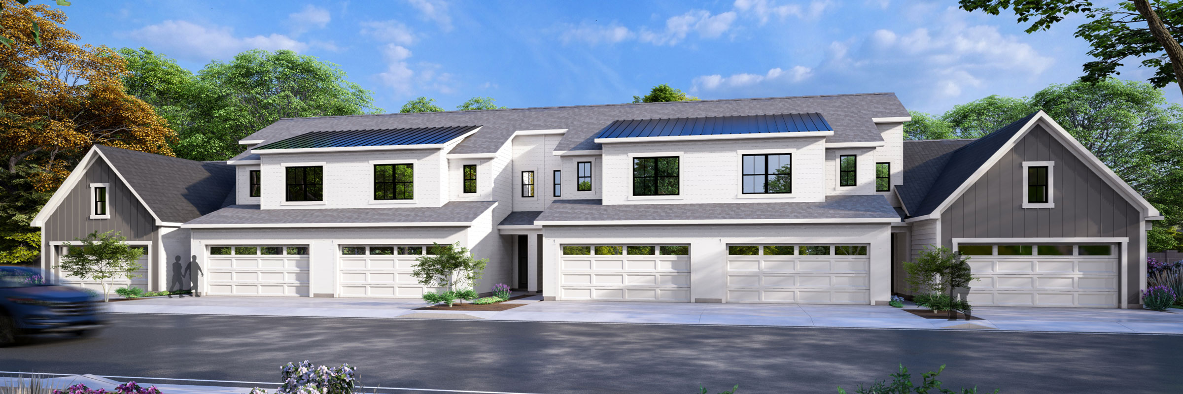 Modern townhouses with garages and greenery