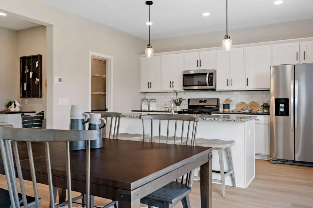 Modern kitchen with wooden table and white cabinets
