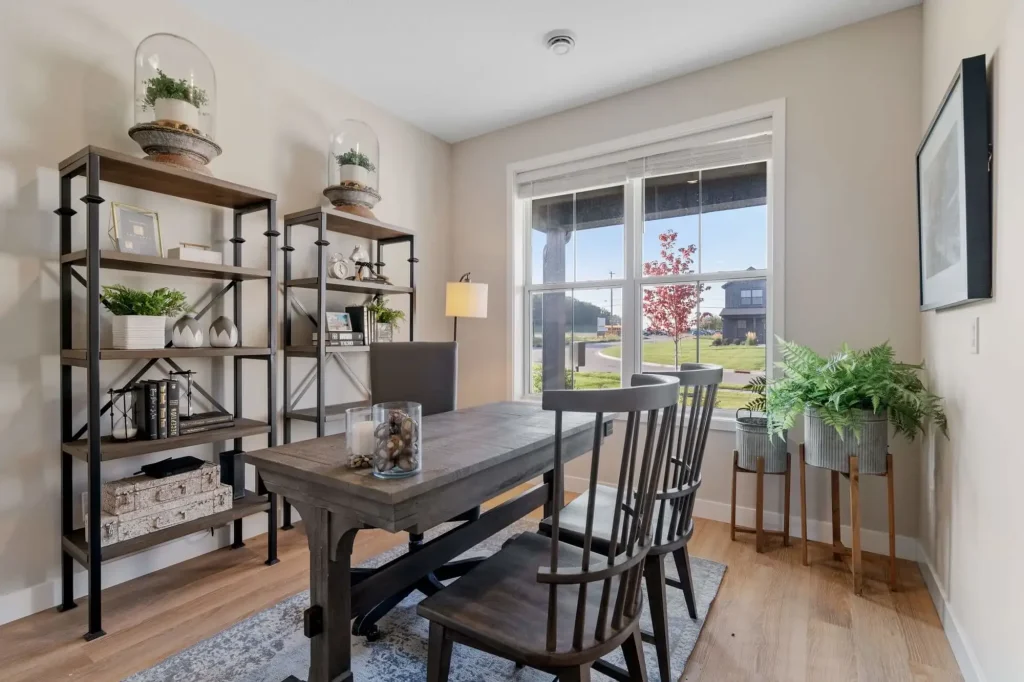 Modern home office with desk and bookshelves.